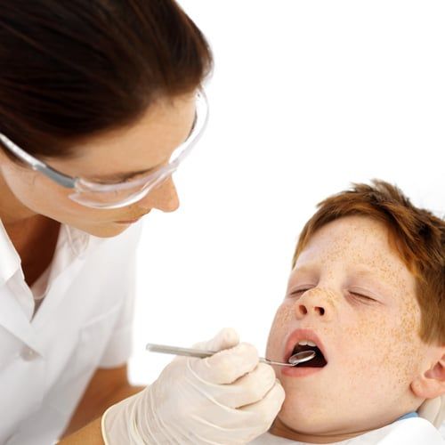 Dentist checking out child